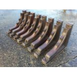 A set of eight late Victorian carved mahogany corbels, the brackets pierced with circular trefoil