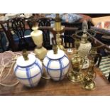 A pair of blue & white handpainted ceramic tablelamps; three brass tablelamps; a turned alabaster