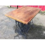 A pine table with rectangular cleated top on Singer sewing machine cast iron base with working