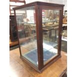 A square Edwardian mahogany counter-top glazed display cabinet, the front with rounded column