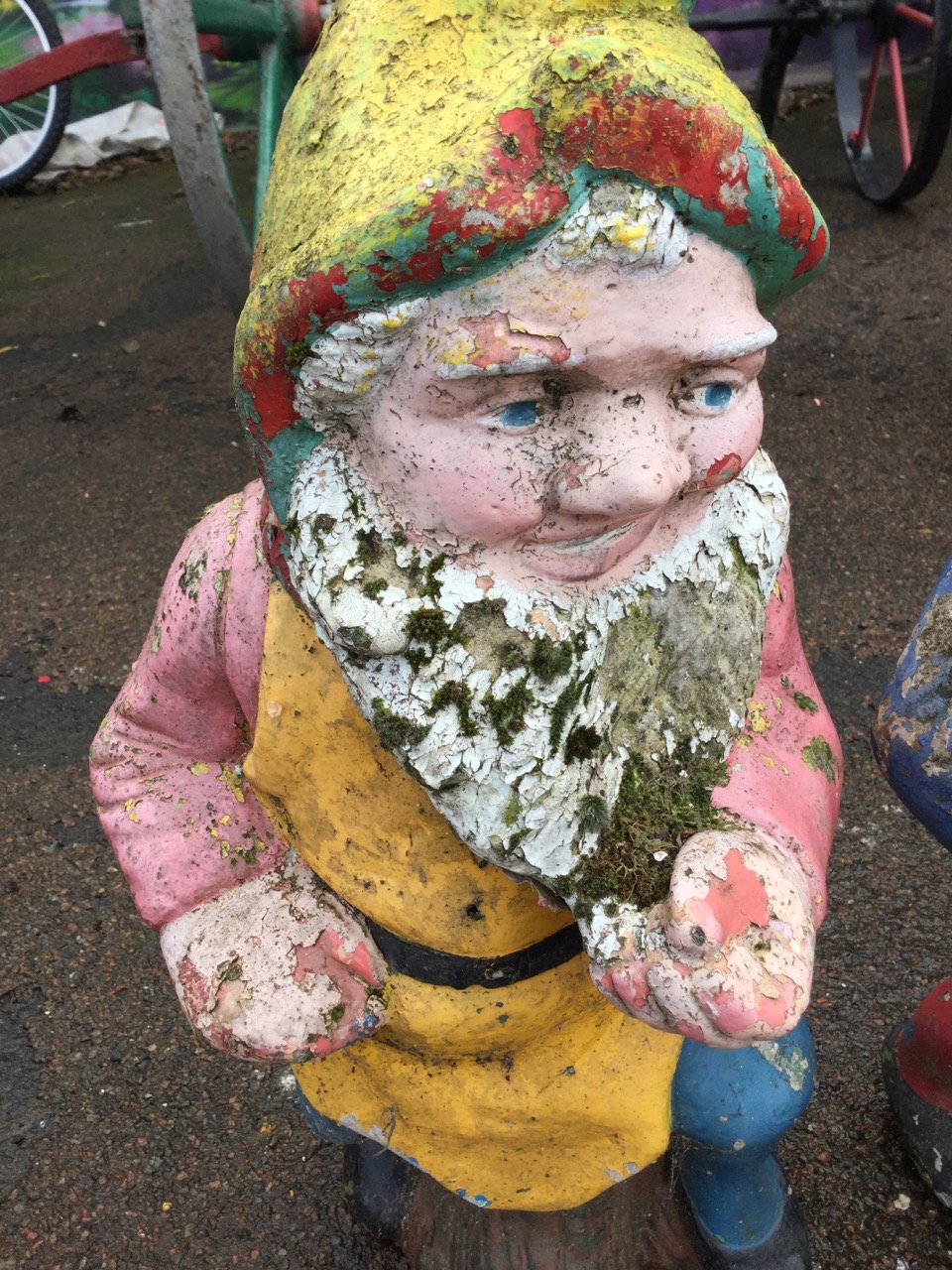 A set of three colourful garden gnomes, the bearded composition stone figures seated on logs. (23in) - Image 3 of 3