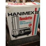 A boxed Hanimex Rondette 35mm slide projector with rotary carousel.