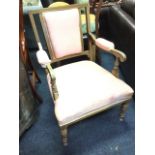 A Victorian rosewood boxwood strung armchair, the back with paterae inlaid arch above an upholstered