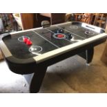 A Tek Score electric air hockey table, the rectangular rounded pitch on shaped legs with digital