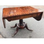 A regency mahogany sofa table, the rectangular crossbanded top with two drop flaps above a frieze