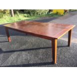 A large rectangular hardwood kitchen table with cleated dowel jointed top on shallow aprons raised