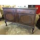A mahogany sideboard, the rectangular gadroon carved top above two frieze drawers, having oval