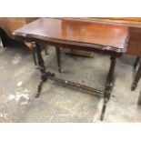 A rectangular Victorian mahogany occasional table, the scalloped moulded top on twin baluster turned