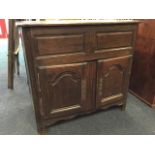 A nineteenth century French oak cabinet, the cleated rounded and moulded top hinging above a
