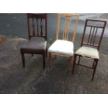 An art nouveau walnut dining chair, the back rail carved with blind fretwork foliate panel above