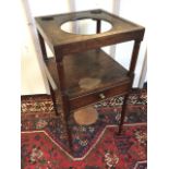 A square Georgian mahogany washstand, the tray top pierced for bowls supported on turned legs, the
