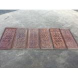 A set of six late nineteenth century rectangular mahogany panels with applied scrolled blind