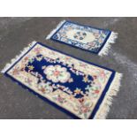 A Chinese thick-pile wool rug woven with oval floral medallion & frieze on blue ground; and