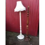 A baluster turned standard lamp on circular base with five bun feet; and another white painted