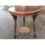 A late nineteenth century circular mahogany lamp table in the style of Godwin, the moulded top on