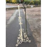 A telescopic late Victorian wrought iron standard lamp with scrolled tripod base supporting a