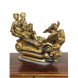 A carved giltwood sleigh group, with children in scrolled carriage lead by an eagle & winged cherub,