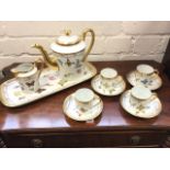 A Limoges four-piece coffee set with tray, all decorated with butterflies and floral sprigs framed