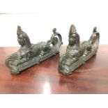 A pair of bronze Sphinx, the stylised beasts with fluted headdresses and scaled cloaks seated on