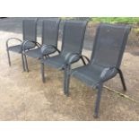 A set of four garden chairs with fabric backs & seats on arched metal frames. (4)
