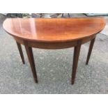 A 'D' shaped mahogany hall table, the plain top on crossbanded frieze, raised on square tapering