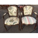 A pair of Louis VI style mahogany fauteuils, the moulded shield shaped backs surmounted by floral