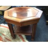 An octagonal hardwood coffee table, the panelled top above a cockbeaded frieze supported on