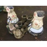 A pair of composition stone painted garden windmill ornaments on circular plinths, with unused