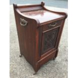 A Victorian mahogany fireside coal cupboard, the top with applied moulding and fluted sides above an