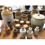 A collection of salt glazed stoneware including kitchen storage jars, cream pots, a bread crock &