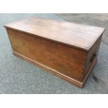 A dovetailed Victorian pine blanket box with carriage handles to ends, supported on moulded plinth.