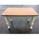 A painted pine kitchen table, the rectangular rounded top on plain rails with turned legs. (47.5in x