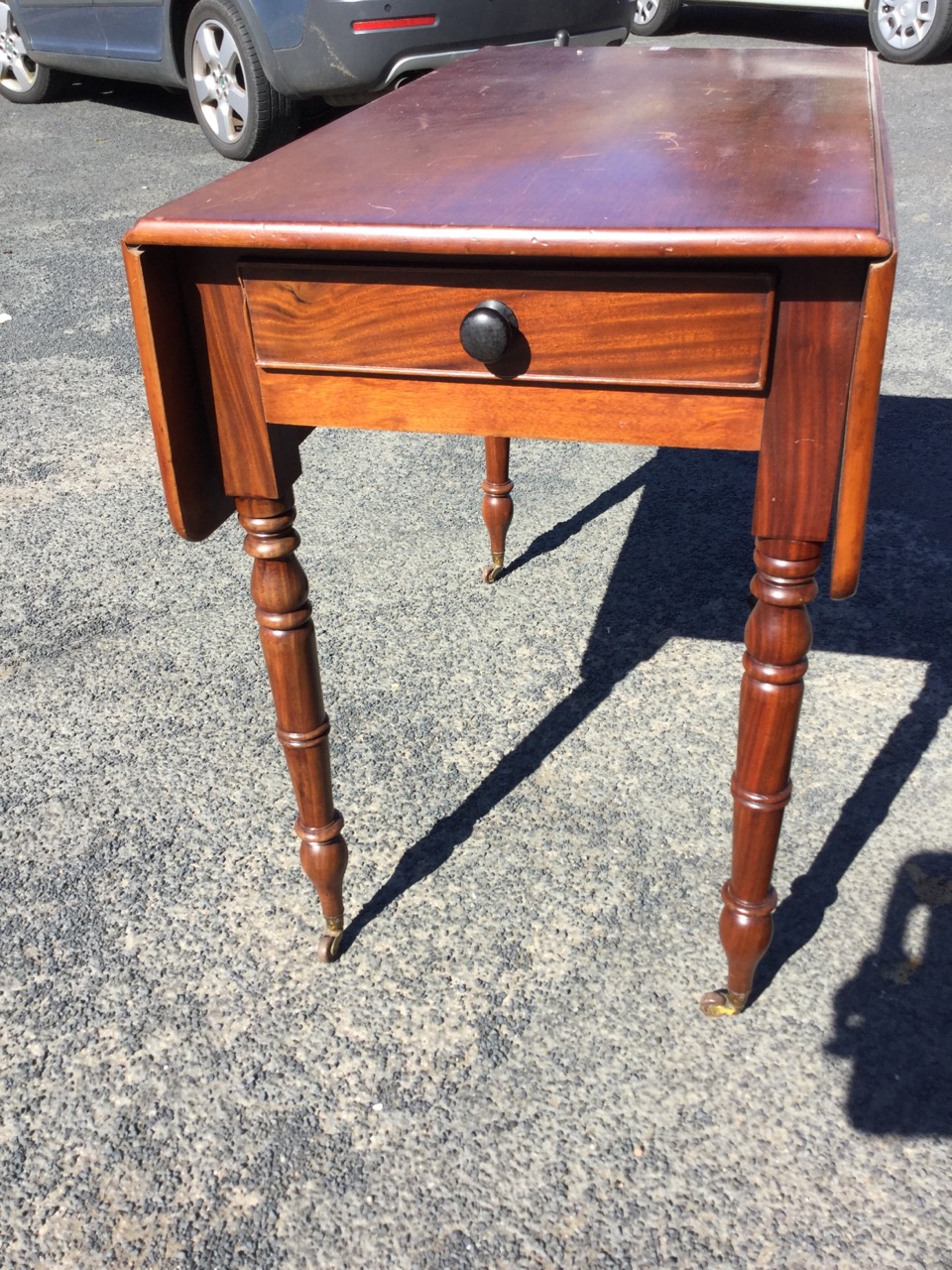 A Victorian mahogany drop-leaf table, having cockbeaded knobbed frieze drawer, raised on turned legs - Image 2 of 3
