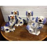 A pair of Staffordshire style wally dogs with orange noses and sponged blue glazes; and another pair