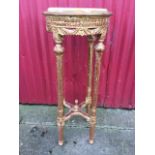 A circular marble topped jardinière stand, the slab in moulded frame with carved swagged aprons,