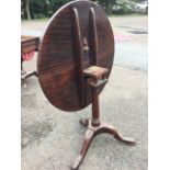 A Georgian circular snap-top mahogany occasional table, the two piece top revolving on a pegged