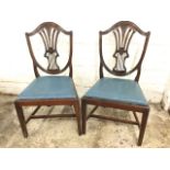 A pair of eighteenth century mahogany Hepplewhite style dining chairs, the shield shaped moulded