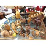 Miscellaneous treen including bowls, carved animals, a pair of candle stands, a weaving shuttle,
