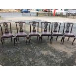 A set of six Chippendale style mahogany dining chairs with pierced back rails and splats above
