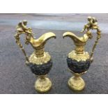 A pair of decorative French bronze ewers, the jugs cast with friezes of gambolling putti having