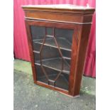 A Victorian mahogany corner cabinet with moulded cornice above astragal glazed door framed by canted