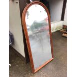 A Victorian arched wall mirror in cushion moulded mahogany frame. (26in x 53in)