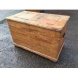 A Victorian dovetailed pine blanket box with panelled top and cranked hinges, the ends with carriage