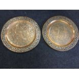 A pair of Persian copper trays, the plaques embossed with exotic birds and foliage in floral