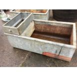 A 3ft galvanised trough with tubular rim, one end mounted with former valve feed compartment. (