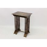 Nest of four Edwardian lacquered occasional tables of typical rectangular form, on spindle supports,