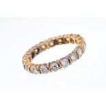 Diamond eternity ring with a full band of nineteen brilliant cut diamonds in 18ct yellow gold