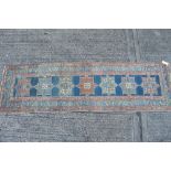 Antique Persian runner with seven quartered medallions on blue ground in geometric borders,