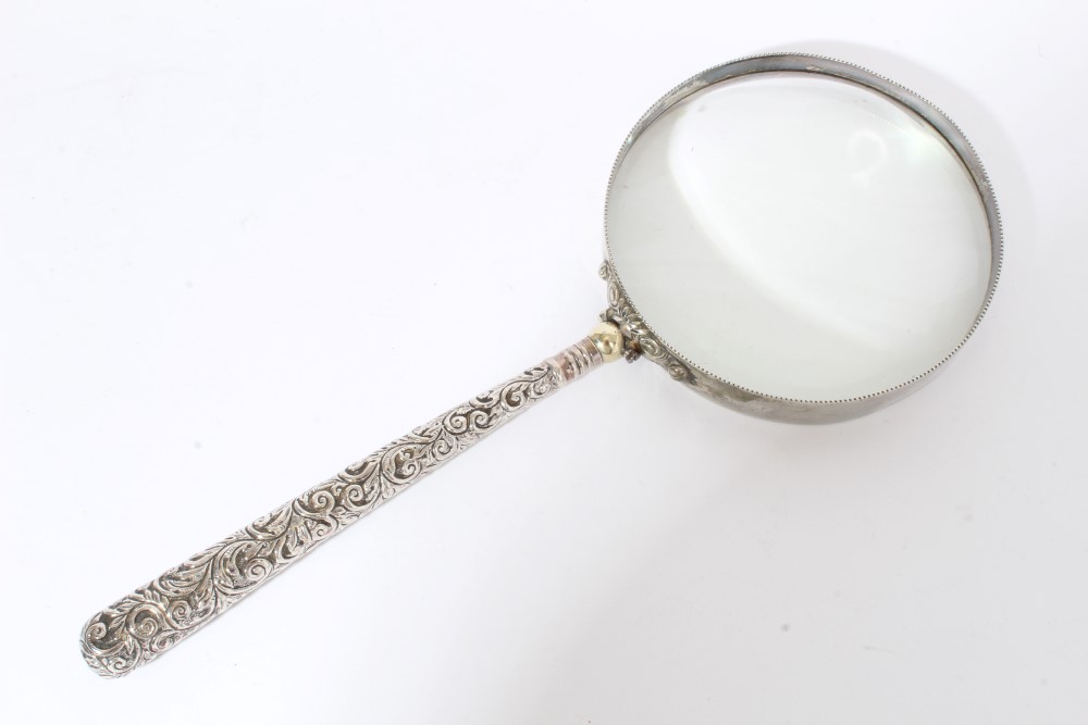 Large silver mounted magnifying glass with Victorian silver foliate decorated handle (Birmingham