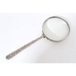 Large silver mounted magnifying glass with Victorian silver foliate decorated handle (Birmingham